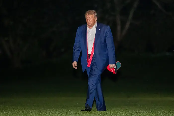 President Donald Trump walks on the South Lawn of the White House in Washington, early, after stepping off Marine One as he returns from a campaign rally in Tulsa.